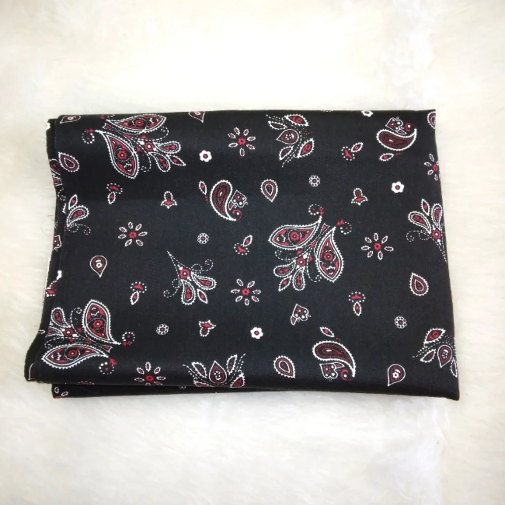 FABRIC Red and white paisley print on black background, twill weave